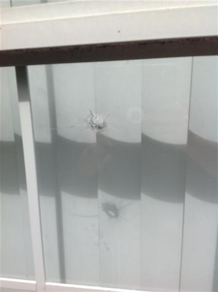 Bullet hole through apartment window